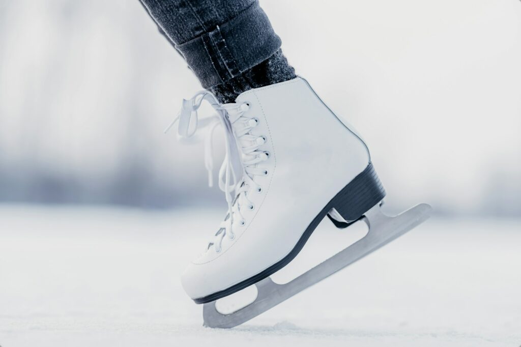 handstand on the tips of ice skates on a frozen winter lake
